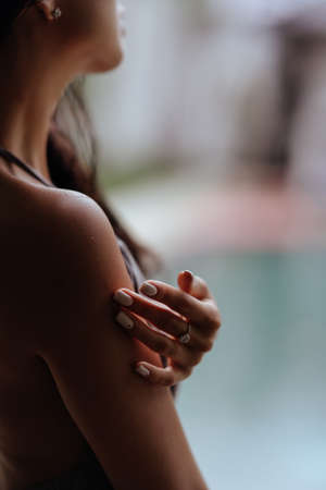 Girl relaxing in the pool on luxury villa in Bali.