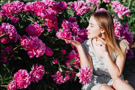 Pink peony flower field.Girl and peoniesの写真素材