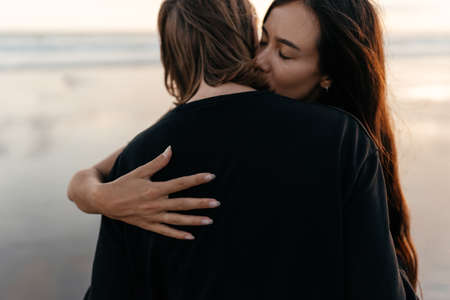 Attractive man and woman enjoying romantic evening on sunsetの写真素材