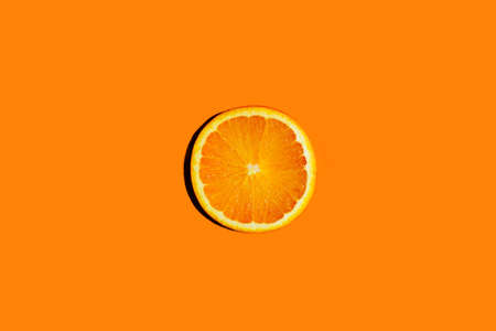 Round orang slice isolate on colorful background.の写真素材