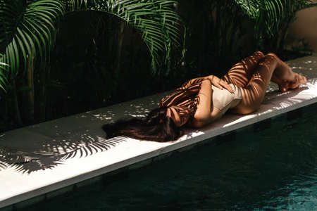 Young black woman relaxing at spa pool.