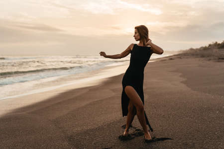 woman on beach is enjoying serene ocean nature during travel holidays vacation outdoorsの写真素材