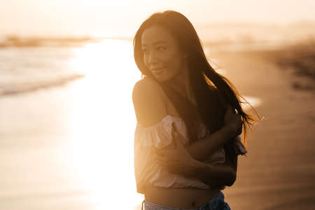 Happy beach girl laughing smiling enjoying sunshine on summer vacation.