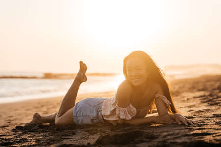 Happy beach girl laughing smiling enjoying sunshine on summer vacation.の写真素材