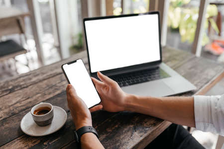Cropped view of man with laptop computer copy space for your text or promotional content, mobile phoneの写真素材