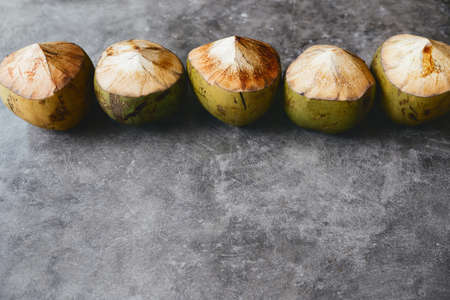 The young coconut is tasty for drinking juice on stone backgroundの写真素材