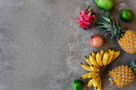 Fresh healthy tropical fruits, pineapple, mango, bananas, dragon fruit.