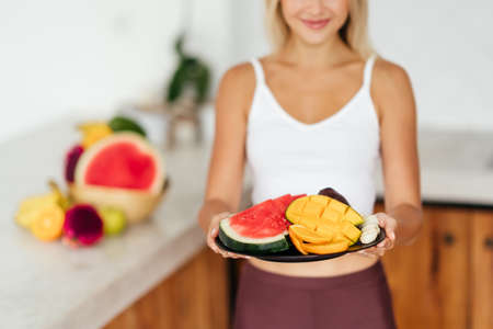 Woman smiling with a tropical fruitsの写真素材