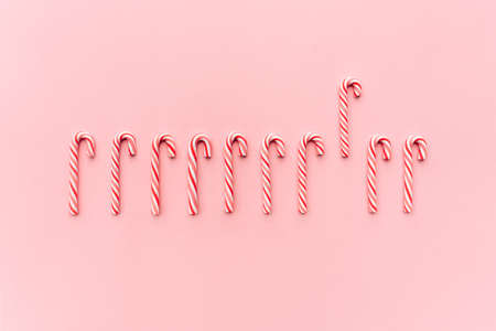 Christmas candy canes on pastel pinkの写真素材
