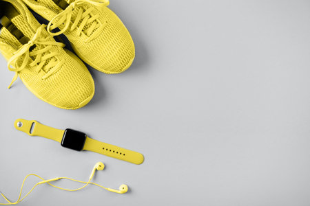 Violet sneakers, headphones and watcheson pink background.の写真素材