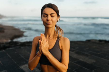 young beautiful woman meditation on beach.の写真素材