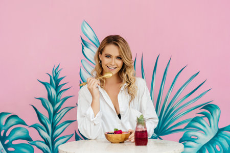 Tan woman chilling and enjoying breakfast during holidays in Baliの写真素材