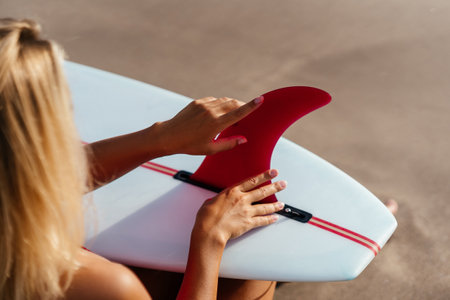 Surf woman with long blonde hair go to ocean.の写真素材