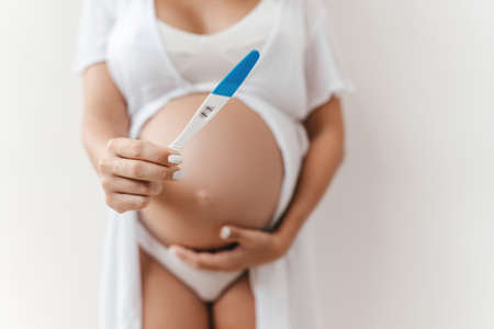 Woman holding pregnancy test, New life and new family concept.の写真素材