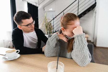 Couple fighting. A young man is trying to have a conversation, while hes been ignored by his girlfriendの写真素材