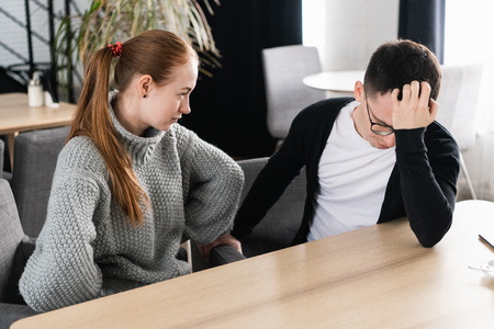 Unhappy young couple arguing, angry wife looking at husband blaming him of problems, conflicts in marriage, bad relationships, man and woman having quarrel or disagreementの写真素材