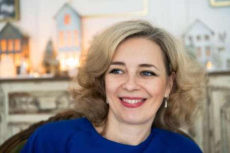Lovely middle-aged blond woman with a beaming smile