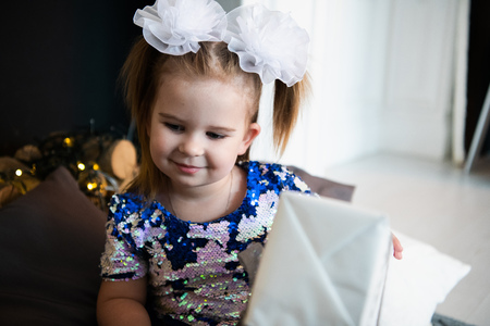Portrait of little pretty girl with birthday giftの写真素材