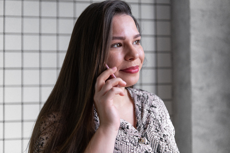 Close up young office woman talking to someone on her phoneの写真素材