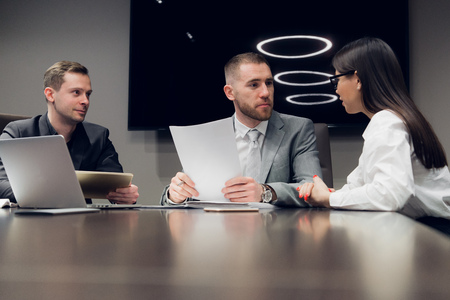 Businesspeople discussing together in conference room during meeting at officeの写真素材