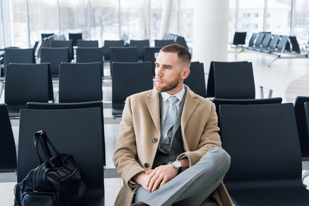 Business man with suitcase in hall of airportの写真素材