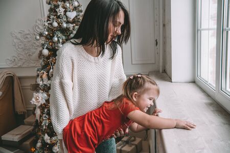 Happy loving family. mother and child girl playing, kissing and huggingの写真素材