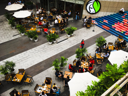 many relaxed people sitting enjoying their lunch in the the street open air cafe. Top view close up.のeditorial素材