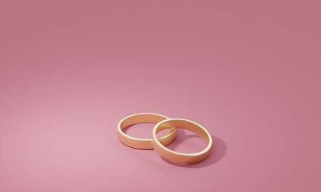 Two gold wedding rings on a pink background. 3d renderingの写真素材