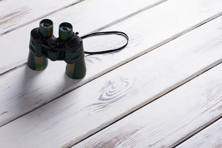 Binoculars standing on wooden boards. Military binoculars.の写真素材