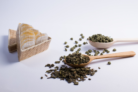 Leaf tea in a wooden spoon and tea bags in  box.の写真素材