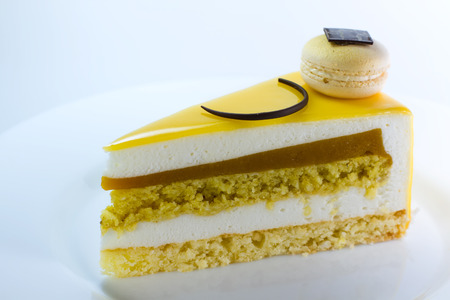 beautiful yellow cake with macaronの写真素材