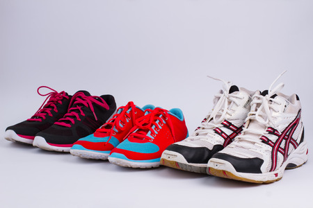 Men's and women's athletic shoes standing in a line.Sport shoes.の写真素材
