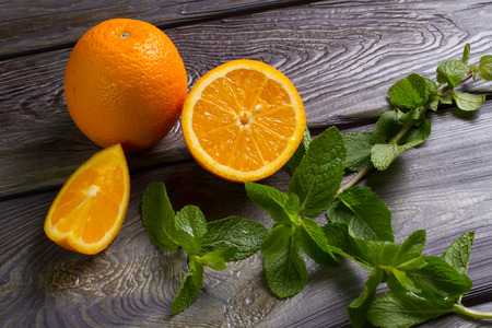 Oranges and mint on wooden base.の写真素材