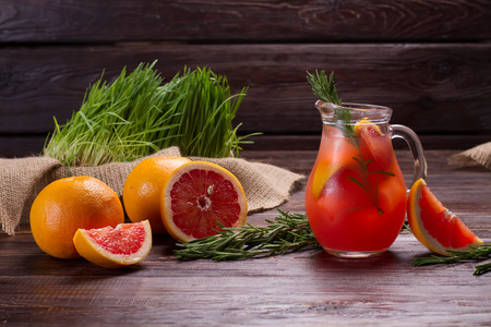 Jug of cold refreshing lemonade with grapefruit and rosemary.の写真素材