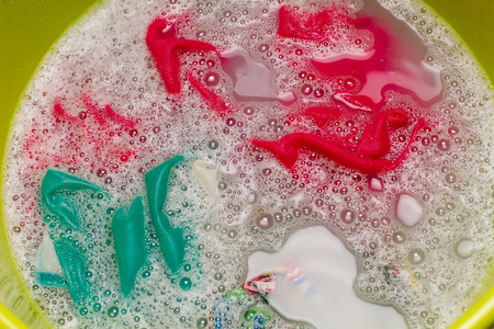 Clothes steeped in a bowl in the foam.