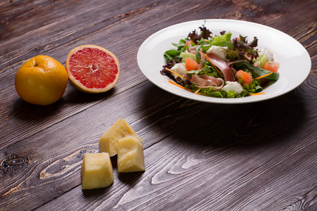 Delicious vegetable salad with grapefruit and jerky.の写真素材