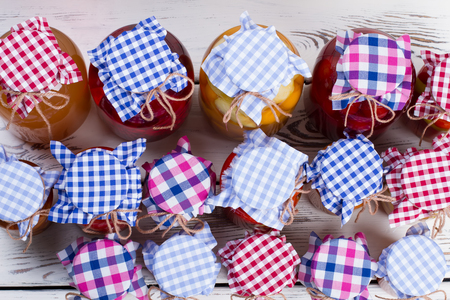 Canned fruits and vegetables in glass jars. Top view. Beautiful design of preservation.の写真素材