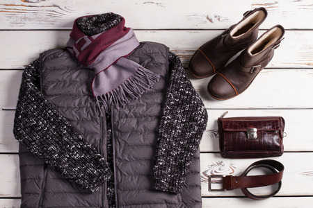 Collection of men's warm autumn clothes on a light wooden background. Goods for internet shop.の写真素材