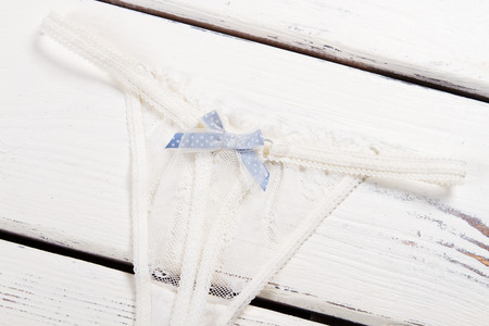 Delicate sexy panties with a blue bow. Women's thong with transparent fabric.の写真素材