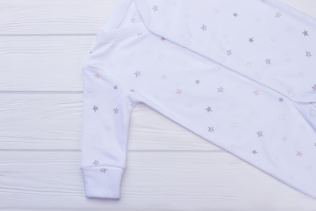 Soft cozy baby boy clothes on wood. White wooden background.の写真素材