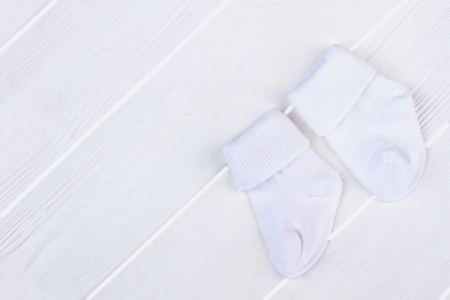 White soft wool socks with copyspace. Wood background.の写真素材