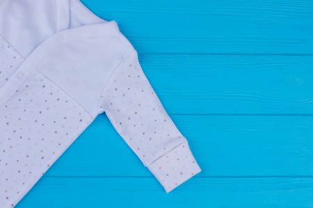 Sleepwear pajamas sleeve. Close up, cropped image. Blue wood background.の写真素材