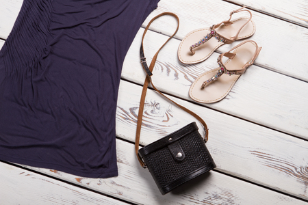 Beige sandals with purple top. Sandals and purse on showcase. Lady's classic handbag and footwear. Stylish retro bag in stock.の写真素材