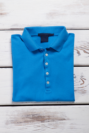 Carefully folded a new T-shirt. Blue polo shirt.の写真素材