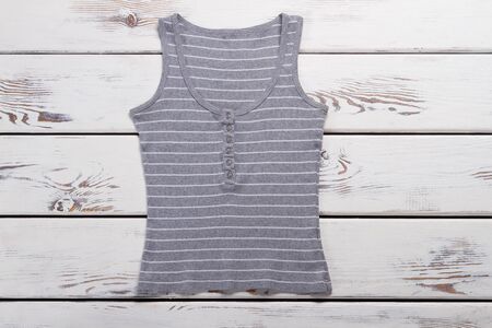 Gray striped tank top. Lady's casual summer top. Garment of high-quality cotton. Clothing item on white table.の写真素材
