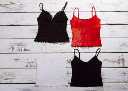 Summer collection of women's tops. T-shirts on wooden background.の写真素材