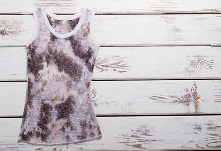 Spotted summer top on white wooden boards.の写真素材