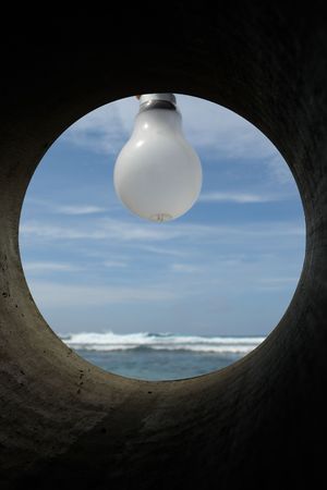 luminous imagination, bulb on bottom ocean, at the end of a pipe symbolizes an idea, the light on the change climatic,の写真素材