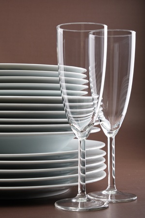 glasses and stack of plateの写真素材
