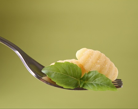 fork with gnocchi and basilの写真素材